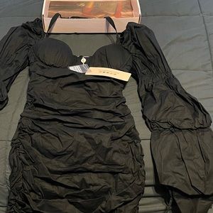 New black mini dress; In body-hugging stretch stretch cotton with ruching.